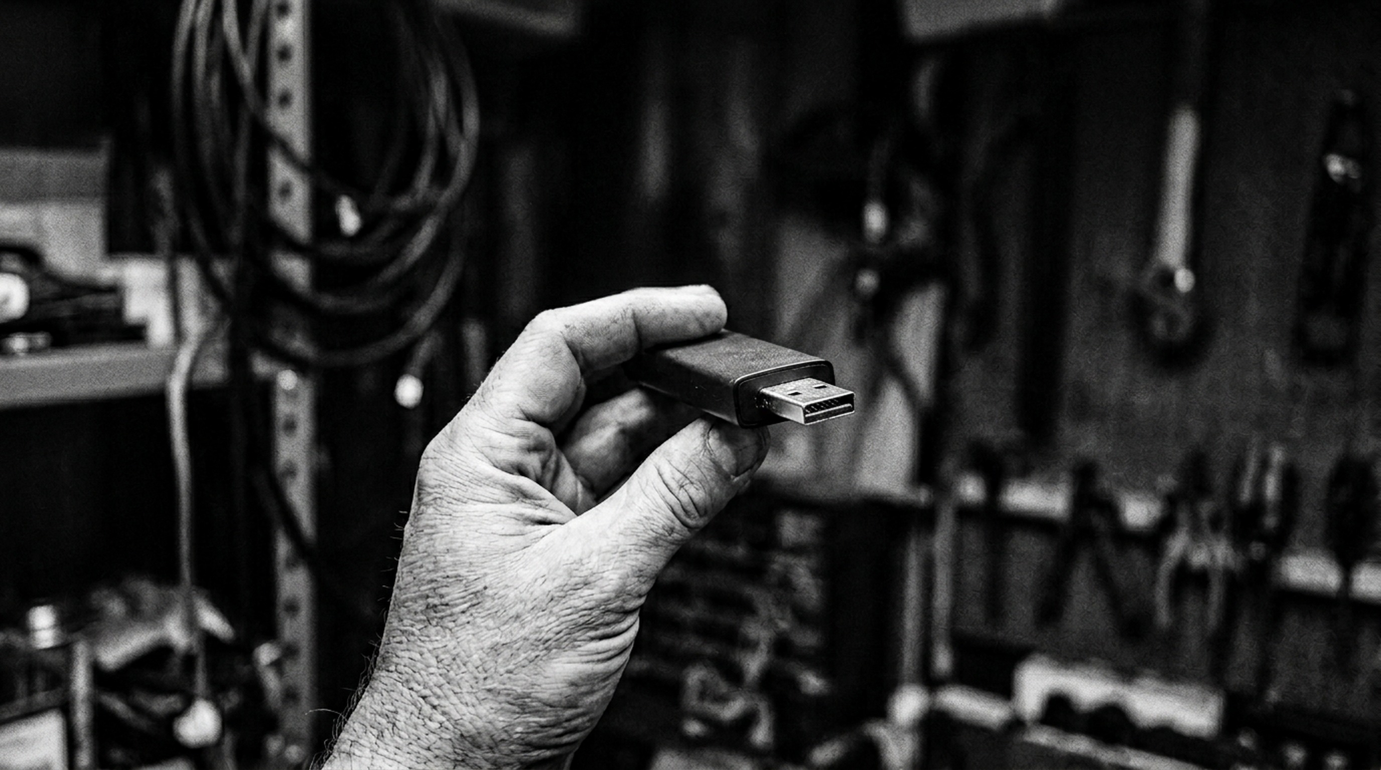 Hand holding streaming stick, forensic documentary photograph