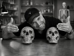 George A. Rauscher with human skull specimens in a forensic laboratory setting