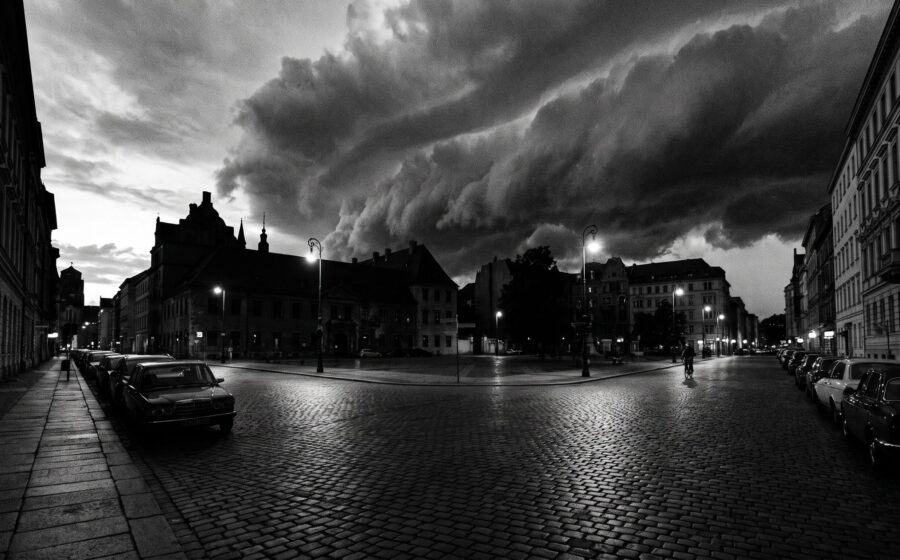 Approaching storm front over a quiet city street at dusk