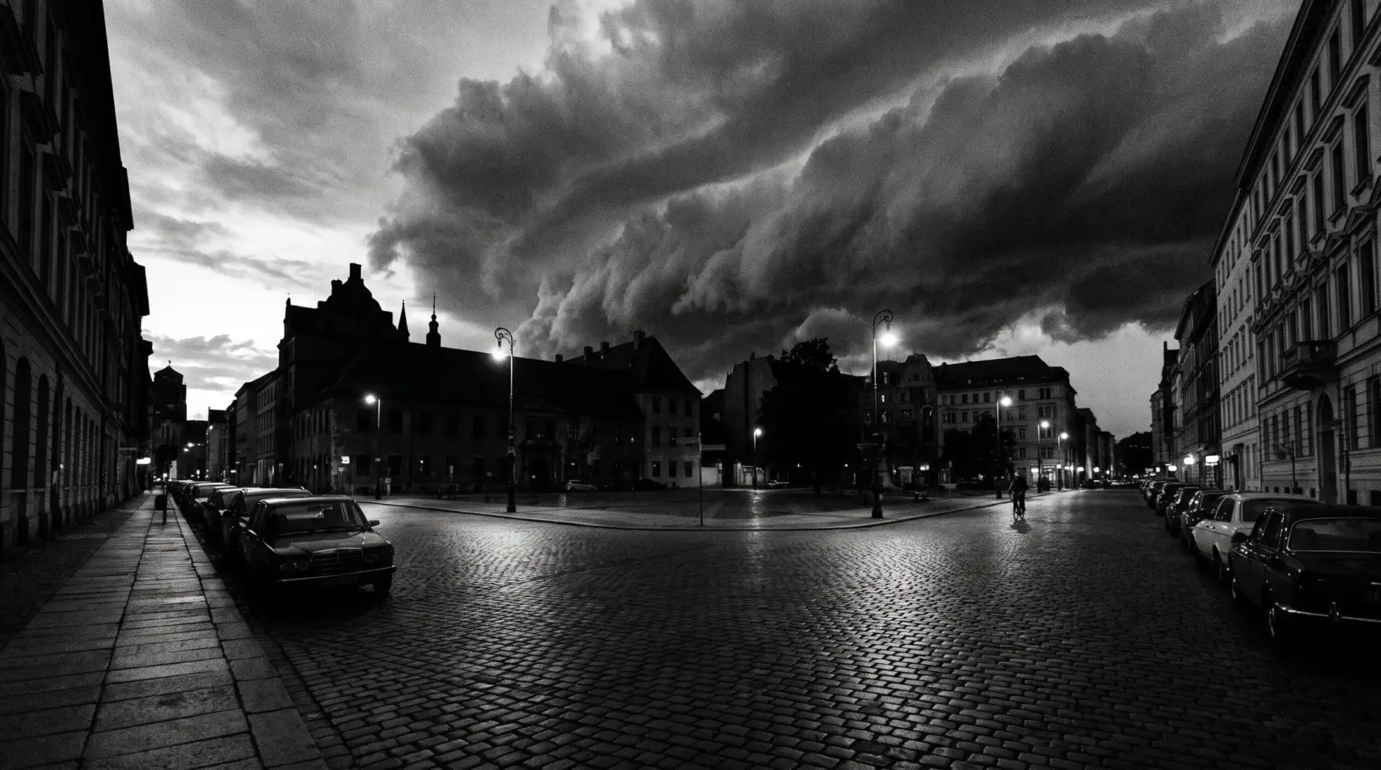 Approaching storm front over a quiet city street at dusk