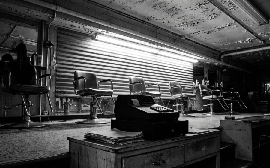 Empty hair salon in landscape, chairs left to right, till and invoices on the counter